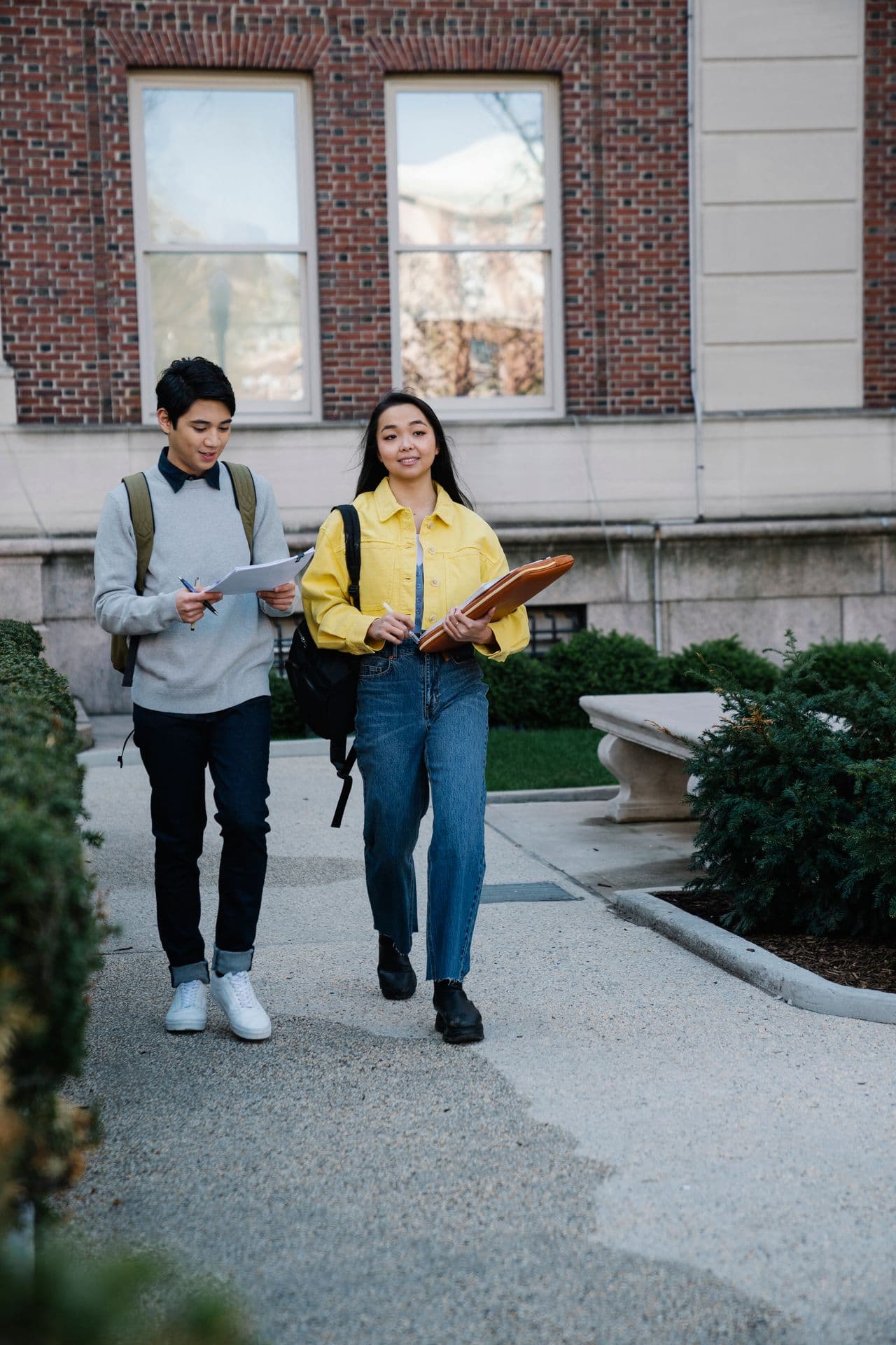 Student walking through campus grounds